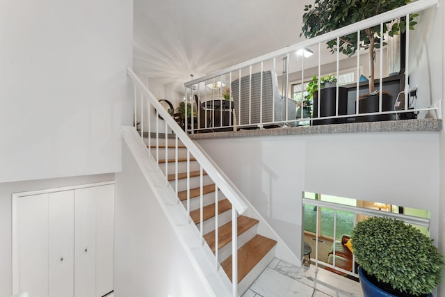 6368 Pheasant Ct, Edina, MN 55436 - stairs featuring healthy amount of natural light and marble finish floors