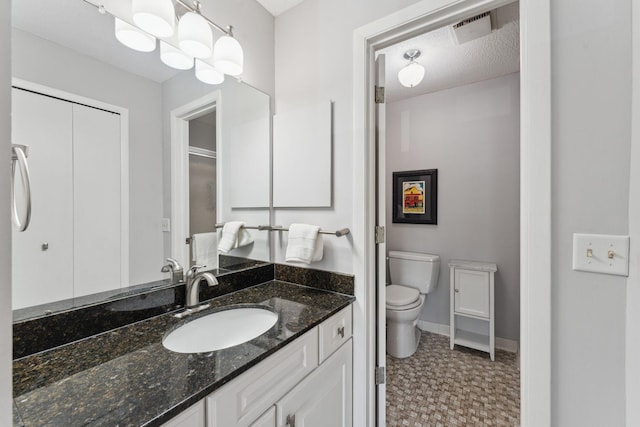 6368 Pheasant Ct, Edina, MN 55436 - bathroom featuring toilet, vanity, baseboards, and tile patterned floors