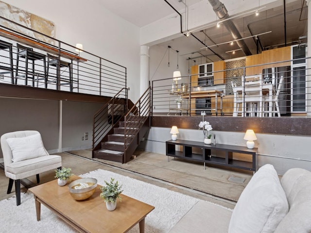 730 Stinson Blvd Unit 106, Minneapolis, MN 55413 - living room with concrete flooring, a towering ceiling, and stairs