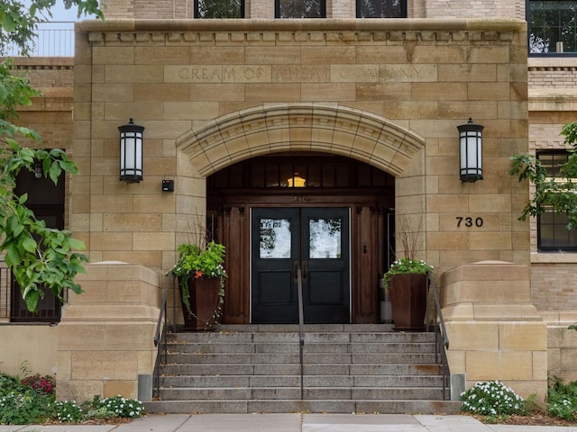 730 Stinson Blvd Unit 106, Minneapolis, MN 55413 - view of exterior entry featuring stone siding, french doors, and brick siding