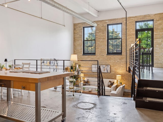 730 Stinson Blvd Unit 106, Minneapolis, MN 55413 - dining area with brick wall, concrete floors, and a high ceiling