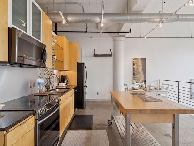 730 Stinson Blvd Unit 106, Minneapolis, MN 55413 - kitchen with appliances with stainless steel finishes, light brown cabinetry, backsplash, and dark countertops