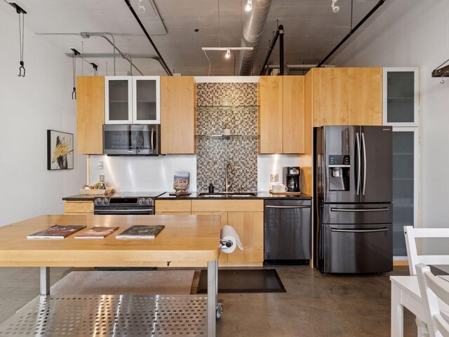 730 Stinson Blvd Unit 106, Minneapolis, MN 55413 - kitchen with appliances with stainless steel finishes, tasteful backsplash, dark countertops, finished concrete flooring, and glass insert cabinets