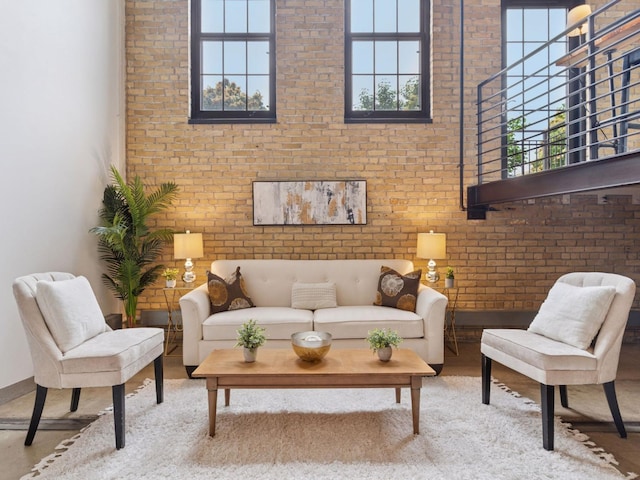 730 Stinson Blvd Unit 106, Minneapolis, MN 55413 - living room with healthy amount of natural light, brick wall, a high ceiling, and wood finished floors