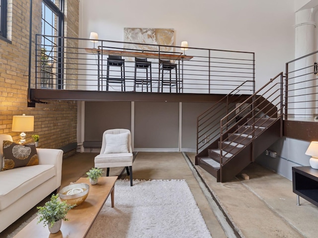 730 Stinson Blvd Unit 106, Minneapolis, MN 55413 - living area featuring concrete floors, a high ceiling, and brick wall