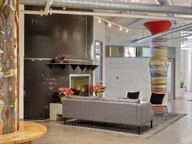 730 Stinson Blvd Unit 106, Minneapolis, MN 55413 - living room featuring concrete floors, a towering ceiling, and rail lighting