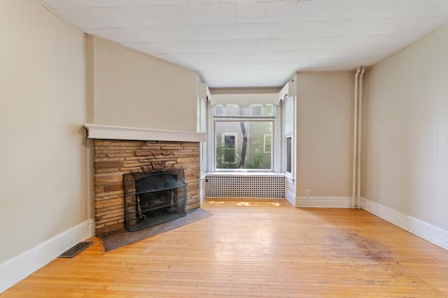 1511 4th St, Duluth, MN 55812 - unfurnished living room featuring hardwood / wood-style floors, a fireplace, and baseboards