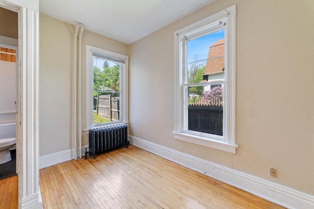 1511 4th St, Duluth, MN 55812 - spare room featuring radiator, hardwood / wood-style floors, and baseboards