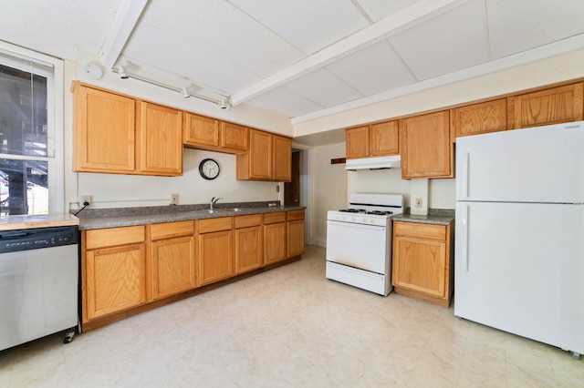 1511 4th St, Duluth, MN 55812 - kitchen with white appliances, under cabinet range hood, dark countertops, and light floors
