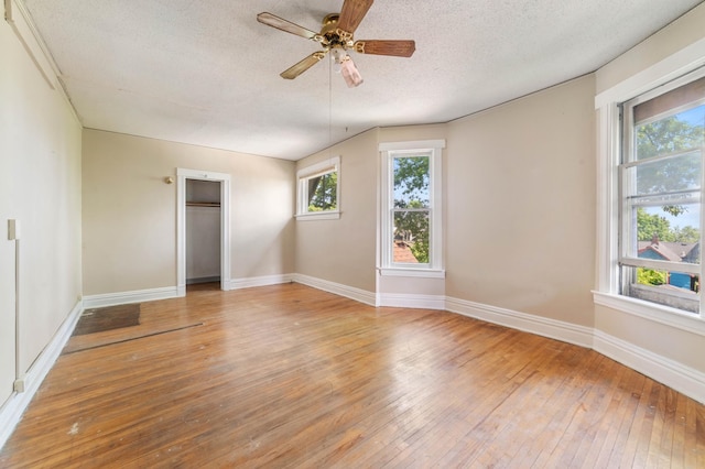 1511 4th St, Duluth, MN 55812 - spare room featuring light wood-style flooring, a textured ceiling, plenty of natural light, ceiling fan, and baseboards