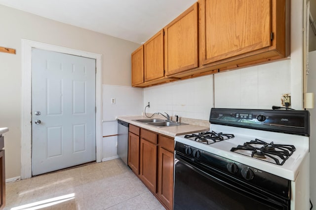 1511 4th St, Duluth, MN 55812 - kitchen with range with gas cooktop, a sink, stainless steel dishwasher, light countertops, and brown cabinetry