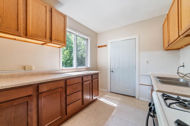 1511 4th St, Duluth, MN 55812 - kitchen with a sink, light countertops, range with gas cooktop, and brown cabinets