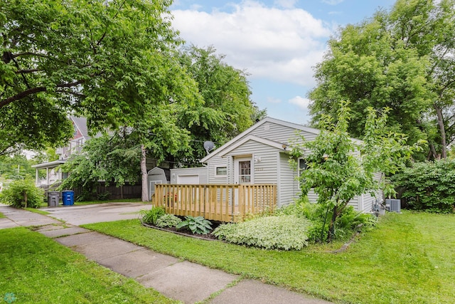 1019 3rd Ave N, Moorhead, MN 56560 - view of front of house with an outbuilding, a front lawn, asphalt driveway, and a wooden deck