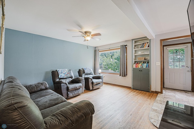 1019 3rd Ave N, Moorhead, MN 56560 - living room featuring ceiling fan, light wood finished floors, and built in shelves