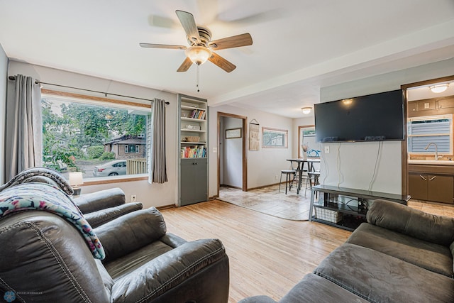 1019 3rd Ave N, Moorhead, MN 56560 - living area featuring a ceiling fan, plenty of natural light, and light wood-style flooring