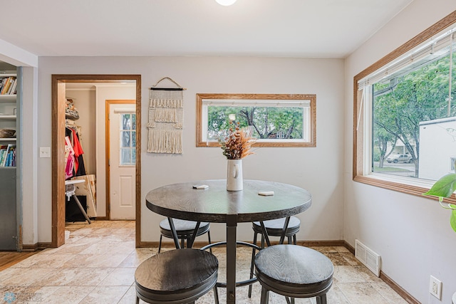 1019 3rd Ave N, Moorhead, MN 56560 - dining area featuring baseboards and light stone finish flooring