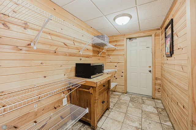 1019 3rd Ave N, Moorhead, MN 56560 - unfurnished office featuring wood walls, a drop ceiling, and light stone finish floors