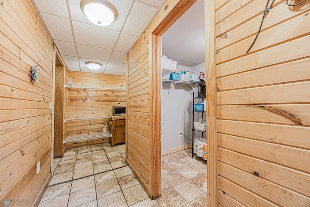 1019 3rd Ave N, Moorhead, MN 56560 - hallway with wood walls and light stone finish floors