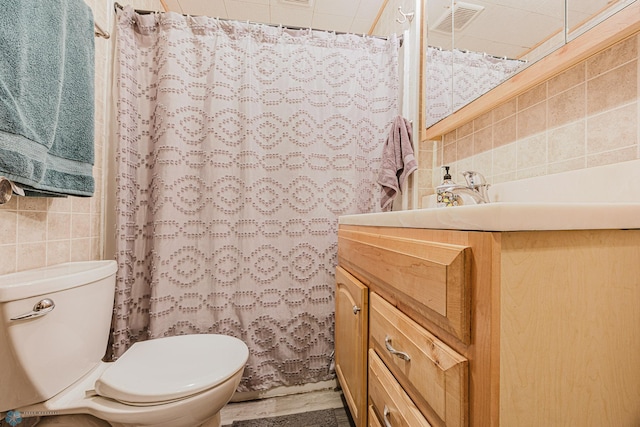 1019 3rd Ave N, Moorhead, MN 56560 - bathroom featuring vanity, tile walls, tasteful backsplash, and a shower with curtain