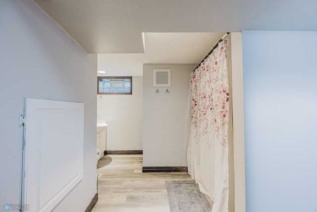 1019 3rd Ave N, Moorhead, MN 56560 - full bath featuring wood finished floors, vanity, and curtained shower