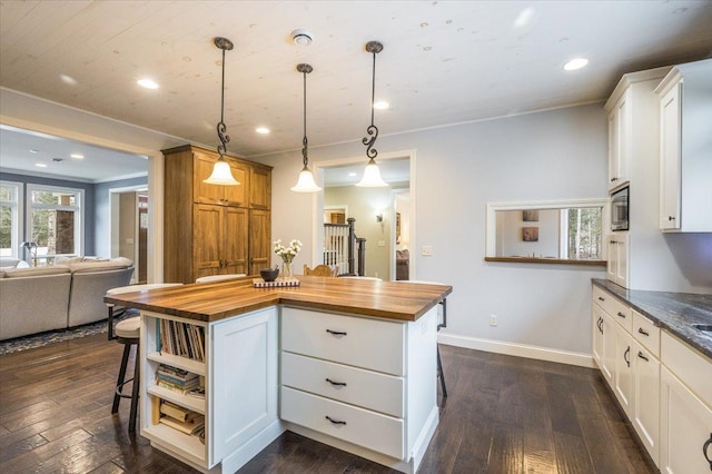 1753 Old N Shore Rd, Duluth Twp, MN 55804 - kitchen with wood counters, dark wood-type flooring, a kitchen breakfast bar, recessed lighting, and crown molding