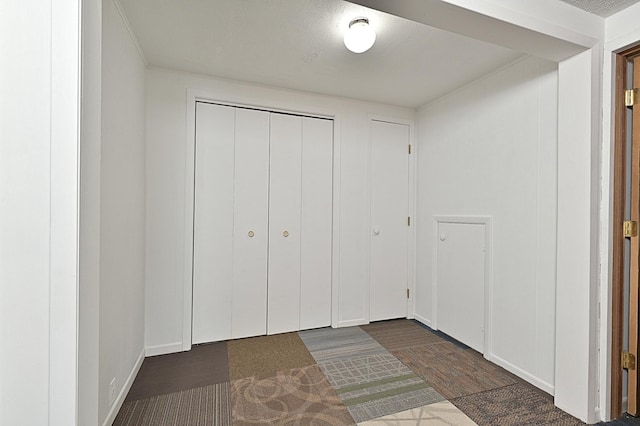 409 3rd St, Bovey, MN 55709 - unfurnished bedroom featuring a closet and dark wood-style floors