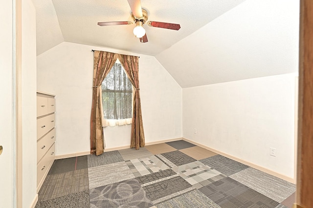409 3rd St, Bovey, MN 55709 - bonus room with lofted ceiling, ceiling fan, a textured ceiling, and baseboards