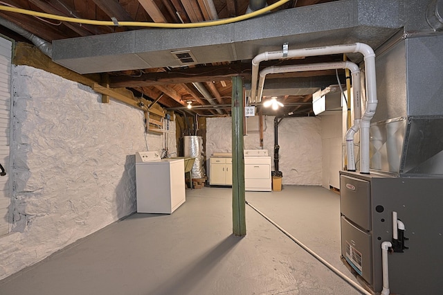 409 3rd St, Bovey, MN 55709 - unfinished basement featuring washer and dryer, heating unit, and water heater