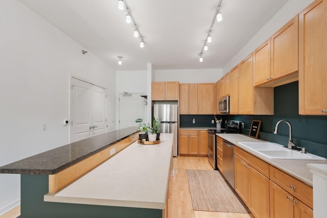445 Wacouta St Unit 403, Saint Paul, MN 55101 - kitchen with appliances with stainless steel finishes, a sink, a kitchen island, light wood-style flooring, and light brown cabinets