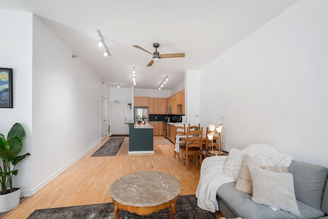 445 Wacouta St Unit 403, Saint Paul, MN 55101 - living area featuring light wood-style floors, ceiling fan, rail lighting, and baseboards