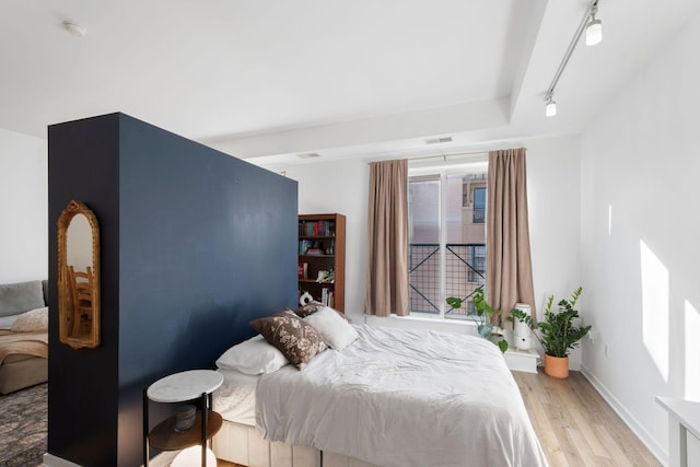 445 Wacouta St Unit 403, Saint Paul, MN 55101 - bedroom with light wood-style flooring, track lighting, and baseboards