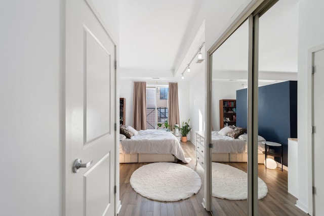 445 Wacouta St Unit 403, Saint Paul, MN 55101 - bedroom with wood finished floors, track lighting, and baseboards