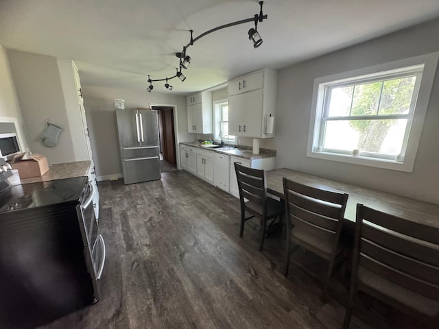 2977 State Highway 68, Marshall, MN 56258 - kitchen featuring appliances with stainless steel finishes, track lighting, dark wood-style flooring, white cabinets, and light countertops
