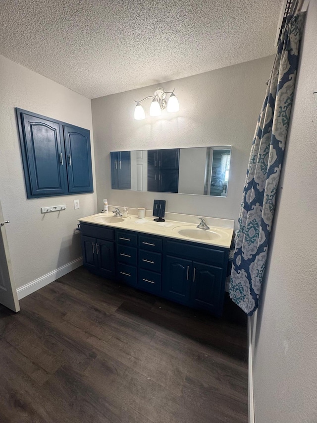 2977 State Highway 68, Marshall, MN 56258 - full bath with wood finished floors, a textured ceiling, double vanity, and a textured wall