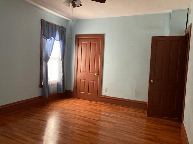 201 Cherry St, Lowry, MN 56349 - unfurnished room with wood finished floors, ceiling fan, and baseboards