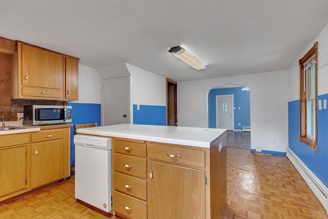 505 Riverside Ave N, Sartell, MN 56377 - kitchen with a baseboard heating unit, stainless steel microwave, white dishwasher, arched walkways, and light countertops