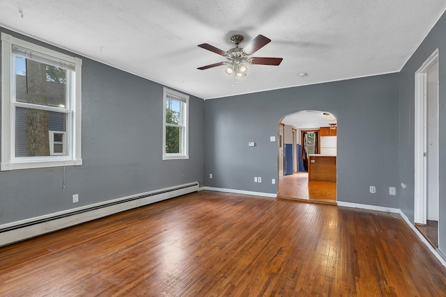 505 Riverside Ave N, Sartell, MN 56377 - unfurnished room featuring baseboard heating, arched walkways, a ceiling fan, wood-type flooring, and a textured ceiling