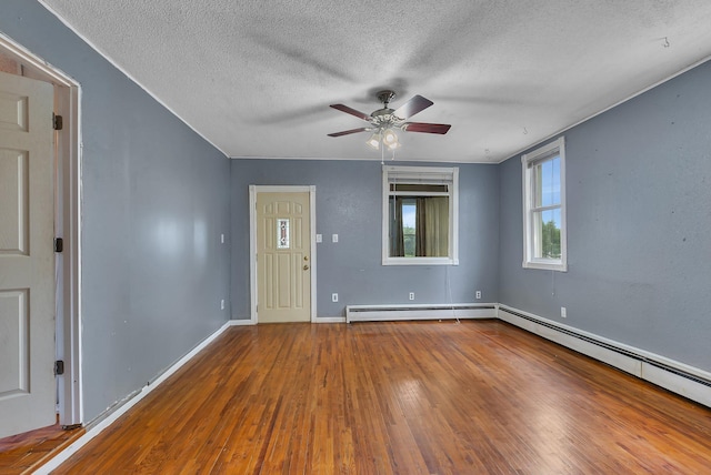 505 Riverside Ave N, Sartell, MN 56377 - spare room featuring a textured ceiling, hardwood / wood-style flooring, baseboard heating, and ceiling fan
