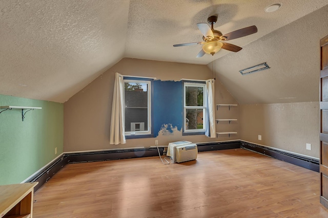 505 Riverside Ave N, Sartell, MN 56377 - additional living space featuring a textured ceiling, wood finished floors, lofted ceiling, and a ceiling fan