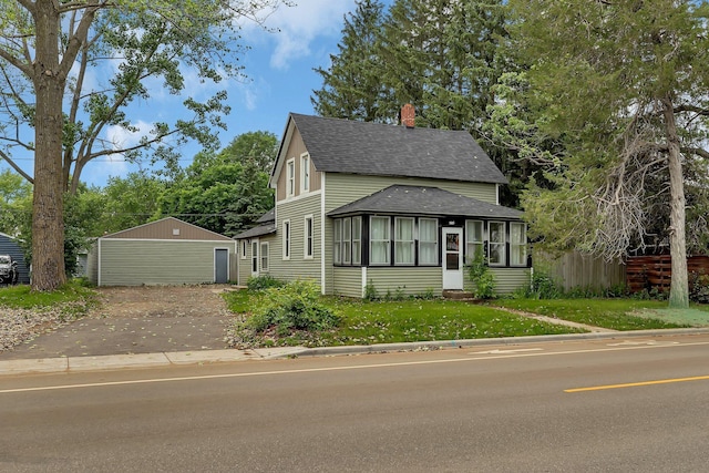 505 Riverside Ave N, Sartell, MN 56377 - view of front facade featuring roof with shingles, a chimney, and an outbuilding