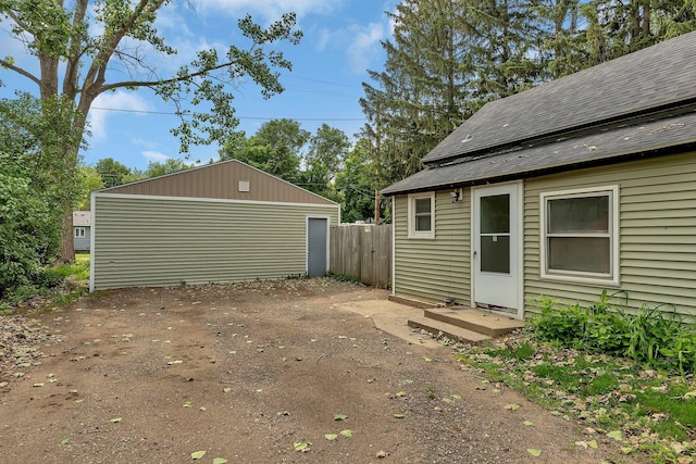 505 Riverside Ave N, Sartell, MN 56377 - view of property exterior featuring a detached garage, an outbuilding, and a shingled roof