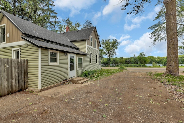 505 Riverside Ave N, Sartell, MN 56377 - view of side of property featuring roof with shingles and a chimney