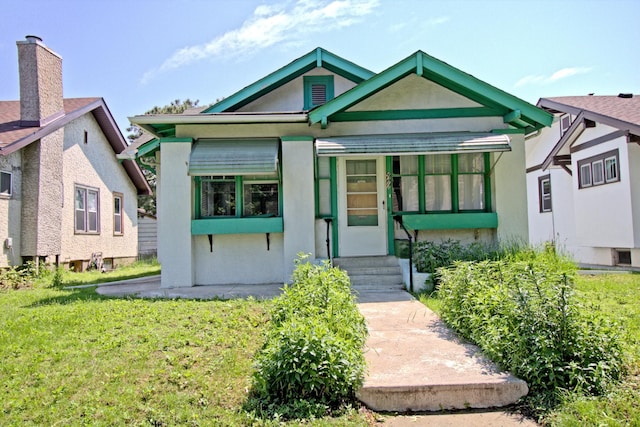 4317 2nd Ave S, Minneapolis, MN 55409 - view of front of house with stucco siding and a front lawn