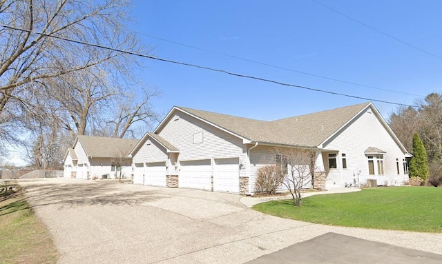 14802 Margaret Pl, Minnetonka, MN 55345 - view of front facade featuring concrete driveway, an attached garage, a front yard, and stone siding