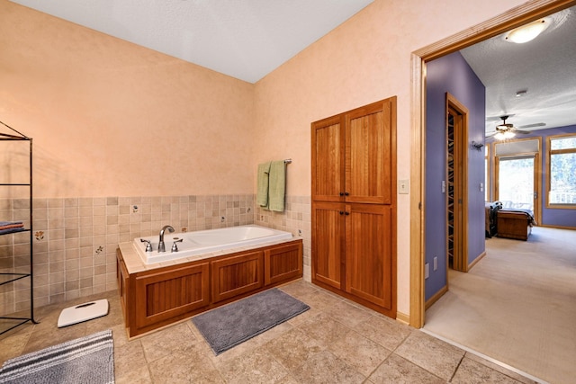 14802 Margaret Pl, Minnetonka, MN 55345 - bathroom featuring tile walls, a garden tub, a ceiling fan, and a wainscoted wall