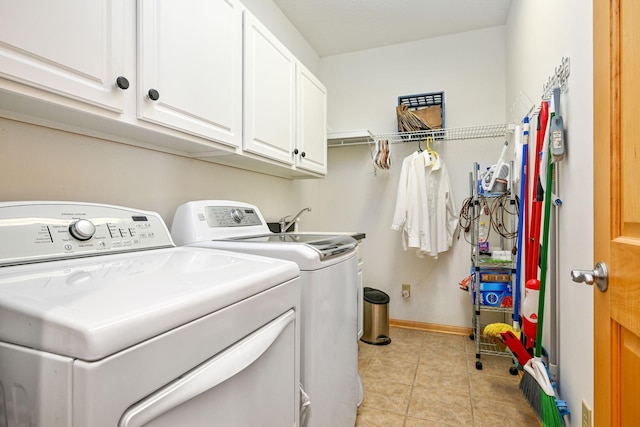 14802 Margaret Pl, Minnetonka, MN 55345 - laundry room with washer and dryer, cabinet space, and light tile patterned floors