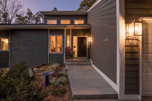 8155 134th St W, Apple Valley, MN 55124 - exterior entry at dusk featuring a chimney