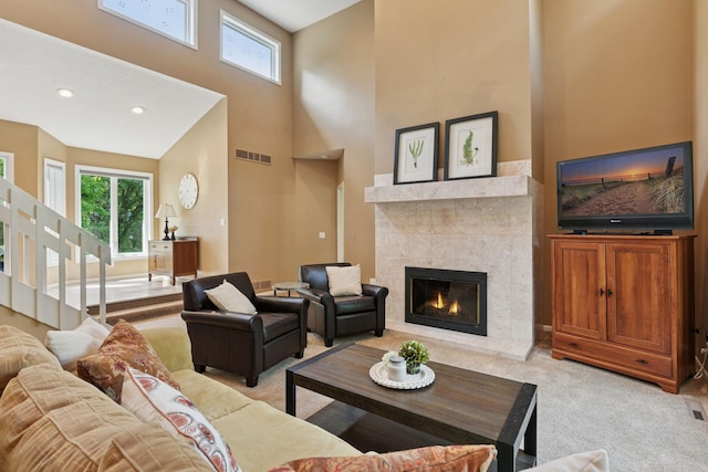8155 134th St W, Apple Valley, MN 55124 - living area with light colored carpet, healthy amount of natural light, a high ceiling, a tile fireplace, and stairs