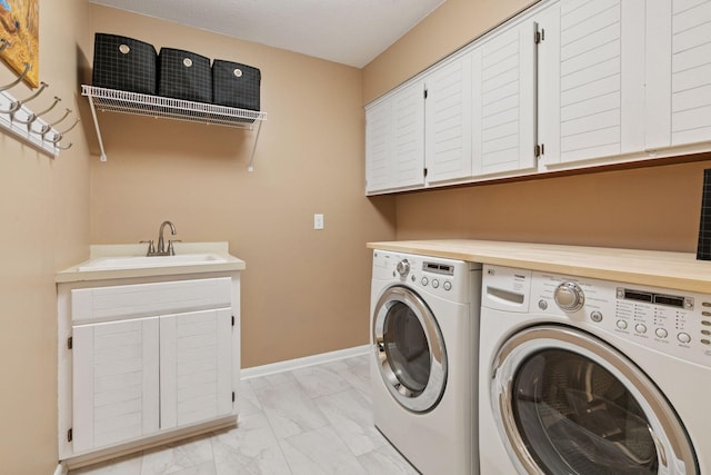 8155 134th St W, Apple Valley, MN 55124 - washroom with washing machine and clothes dryer, cabinet space, light marble finish flooring, and baseboards