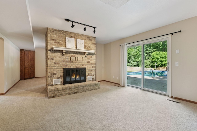 8155 134th St W, Apple Valley, MN 55124 - unfurnished living room with track lighting, carpet floors, and a brick fireplace
